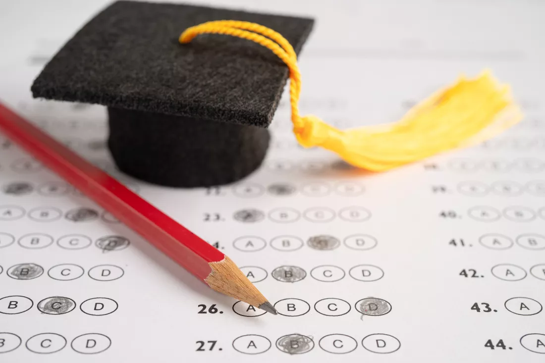 graduation-gap-hat-pencil-answer-sheet-background-education-study-testing-learning-teach-concept